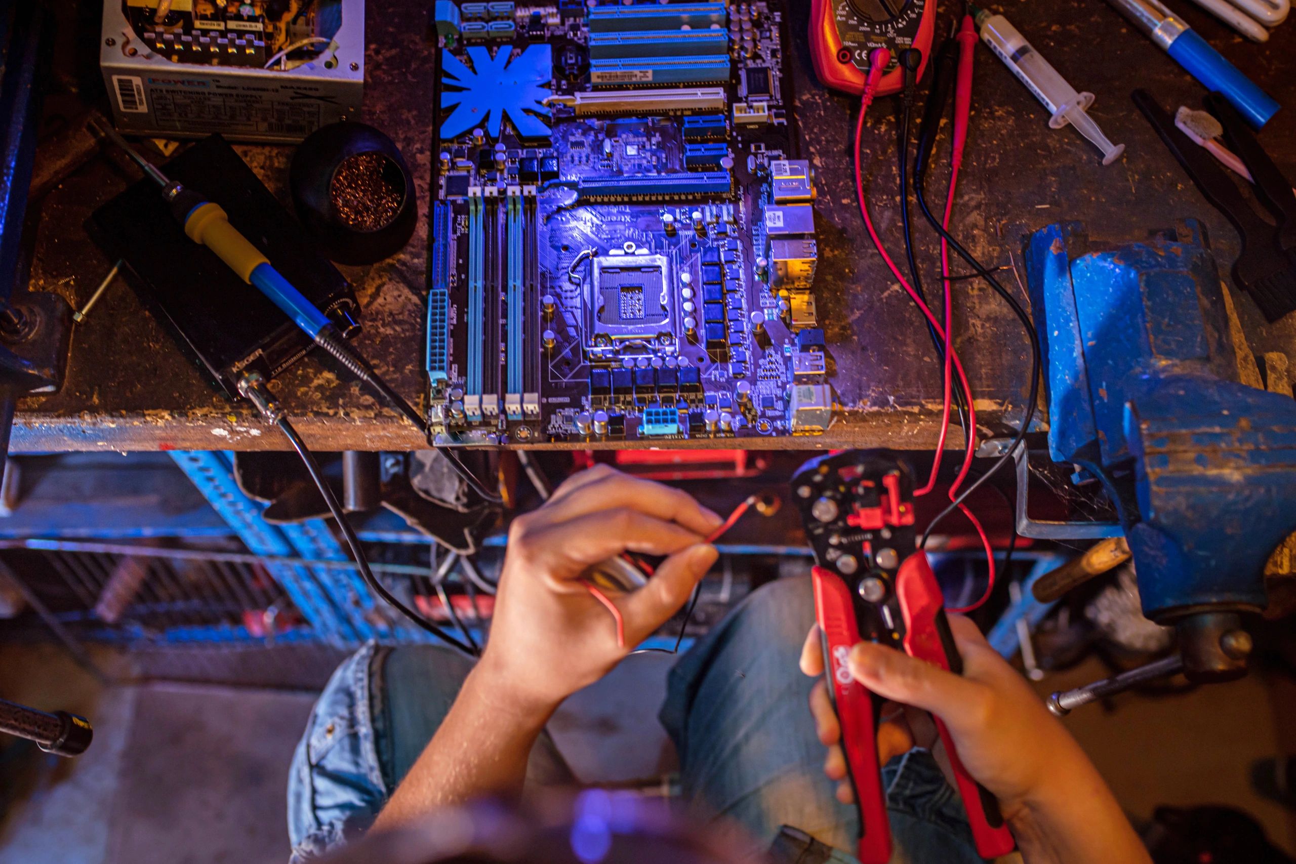 Technician working at a repair bench with tools