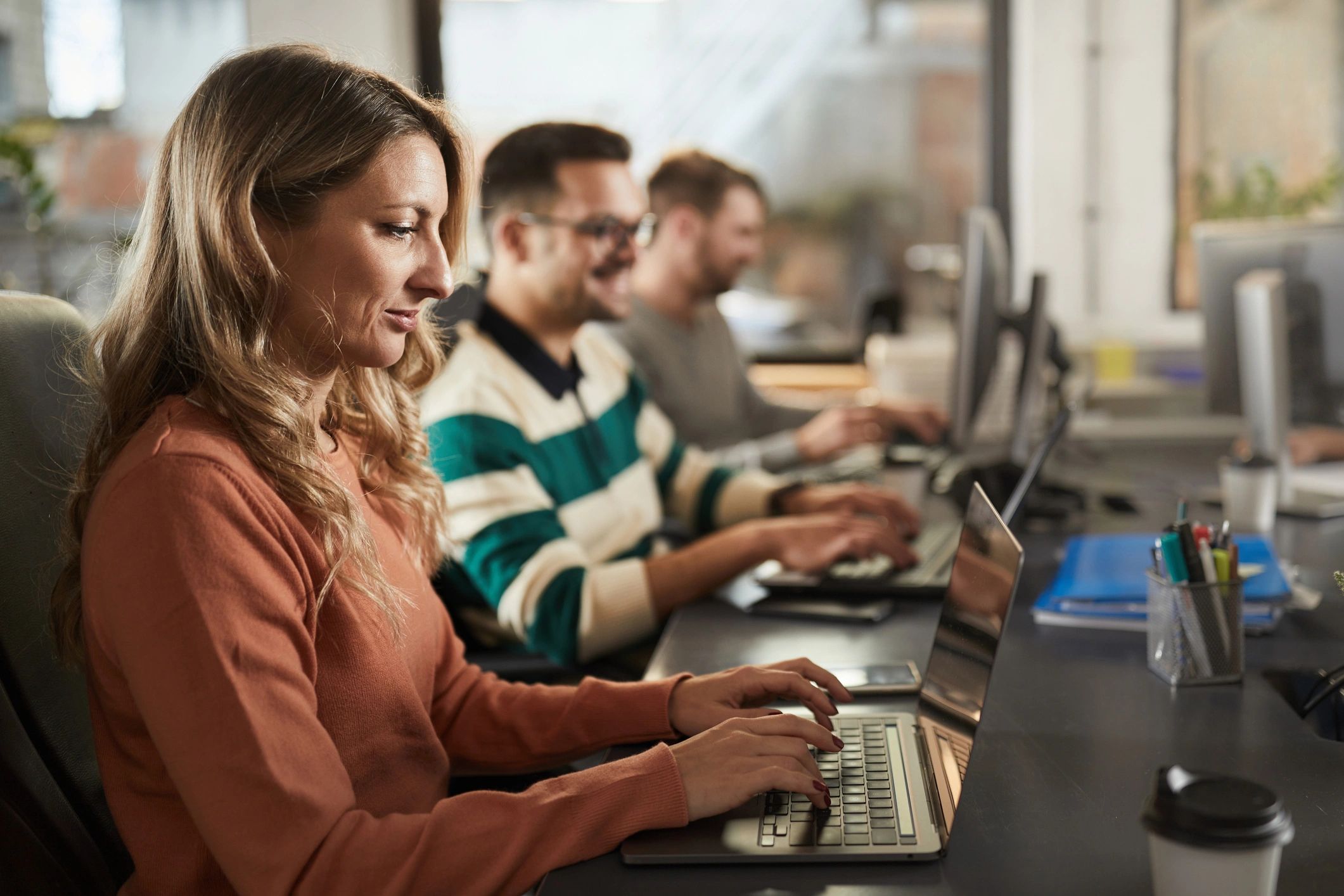 Technician working on a laptop in an office
