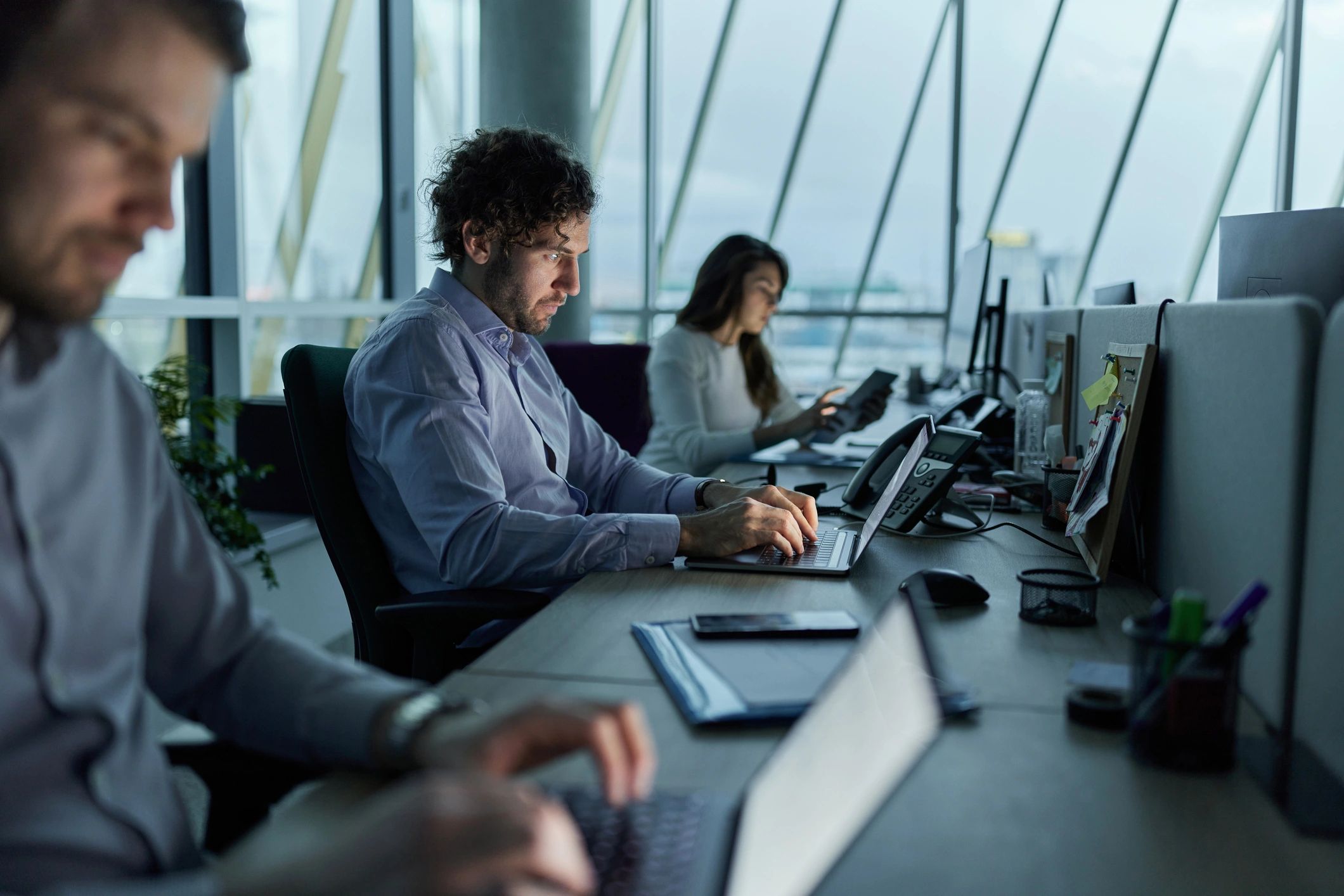 IT team working on laptops in an office