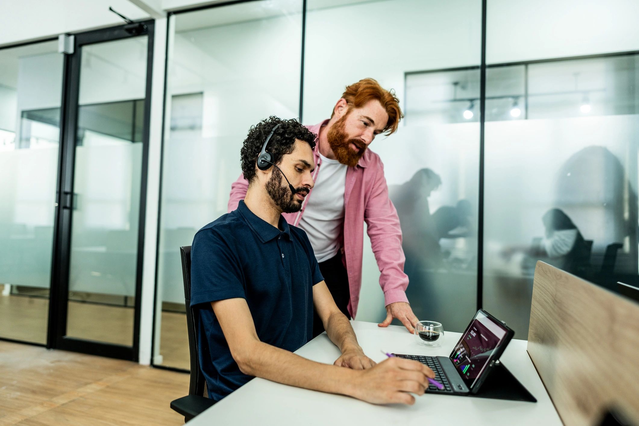 IT support professional assisting a client at a computer