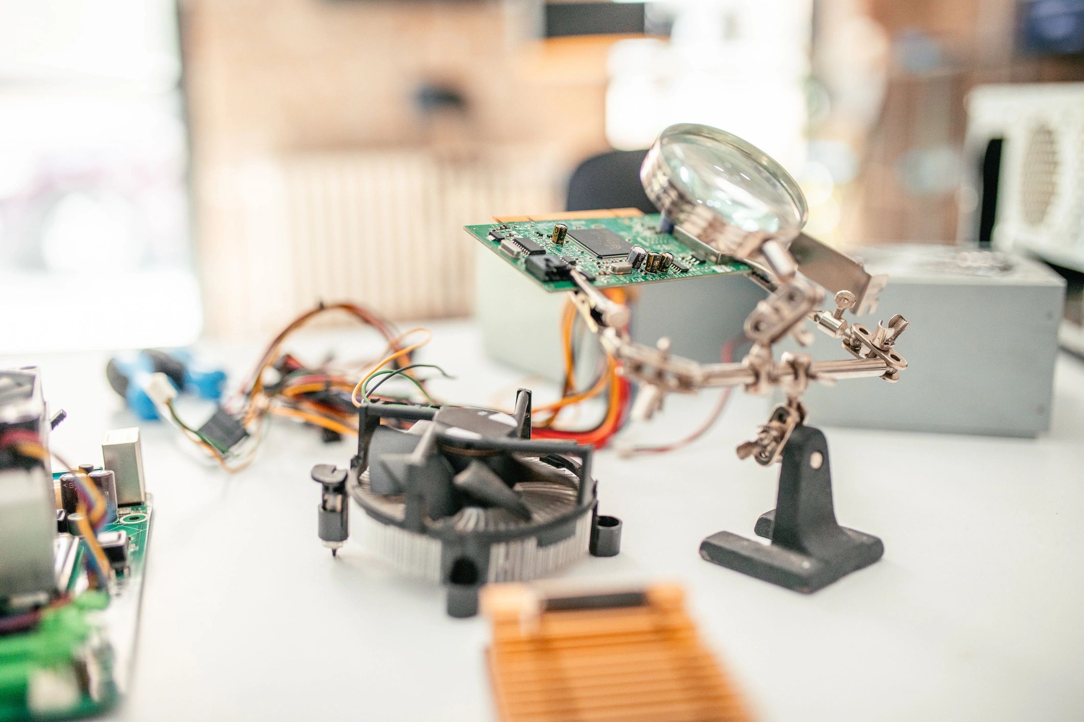 Electronics technician workbench with computer hardware and tools